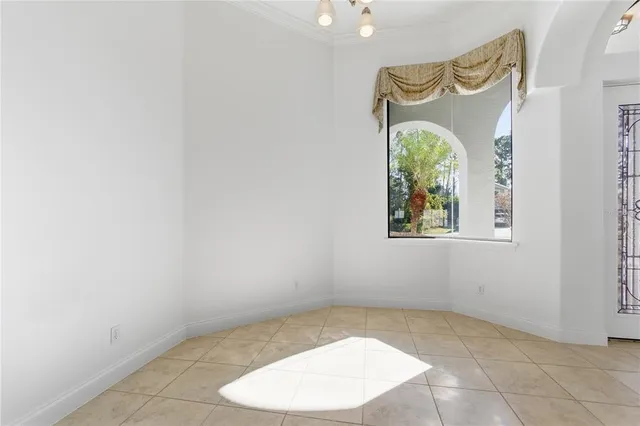 an empty room with a bench and wooden floor