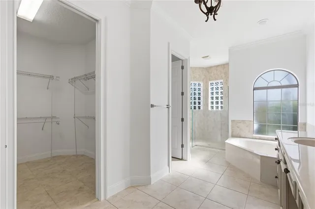 a spacious bathroom with a glass door shower and a sink