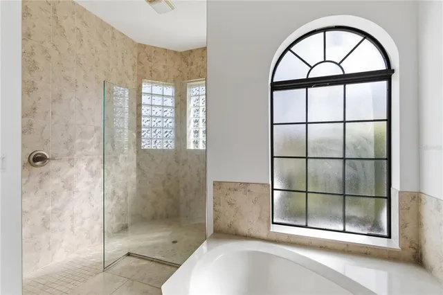 a bathroom with a tub and a window