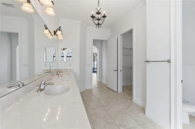 a spacious bathroom with a granite countertop sink a mirror and a shower