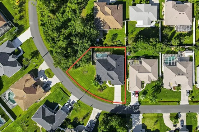 an aerial view of a house with a garden and trees