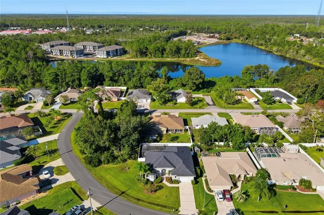 an aerial view of residential houses with outdoor space and river