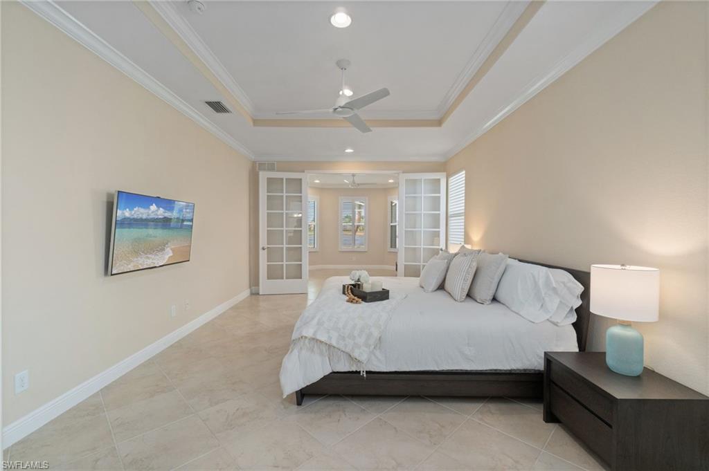 19753 Tesoro Way Estero, FL 33967 - Photo 14 of 47 a spacious bedroom with a bed and window
