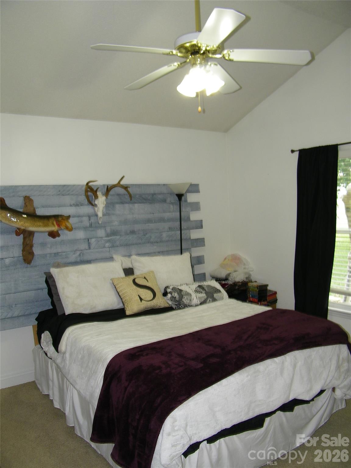 609 Redah Avenue Locust, NC 28097 - Photo 22 of 37 a bedroom with a bed and a chandelier