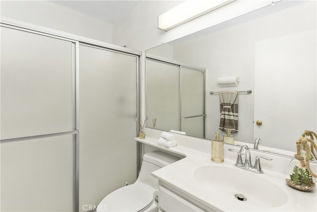 7693 Chanticleer Road Highland, CA 92346 - Photo 8 of 14 a bathroom with a sink toilet and shower