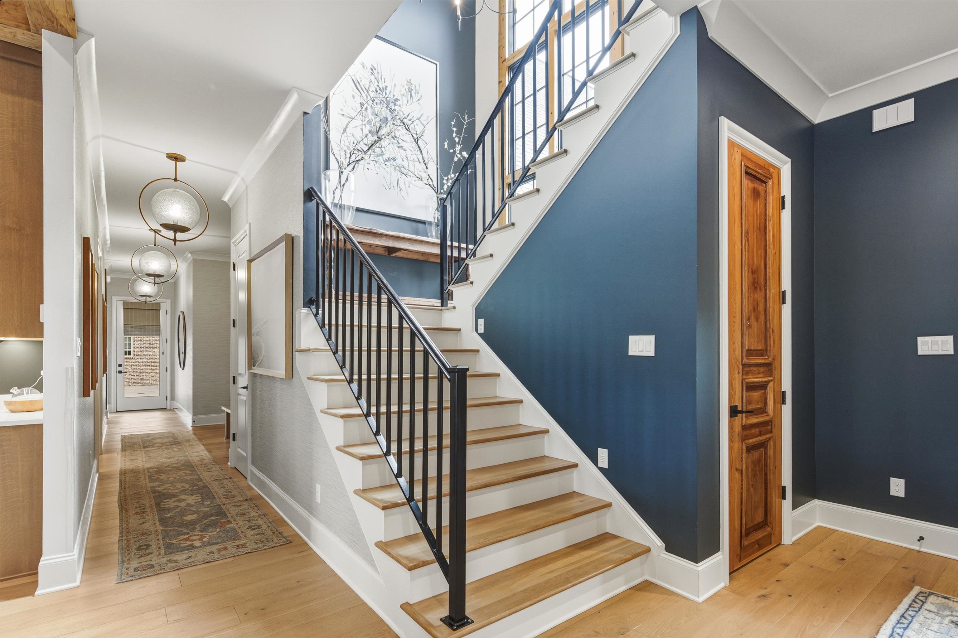 160 North Lake Road Piperton, TN 38017 - Photo 39 of 40 Stairs featuring ornamental molding, wood-type flooring, and a chandelier