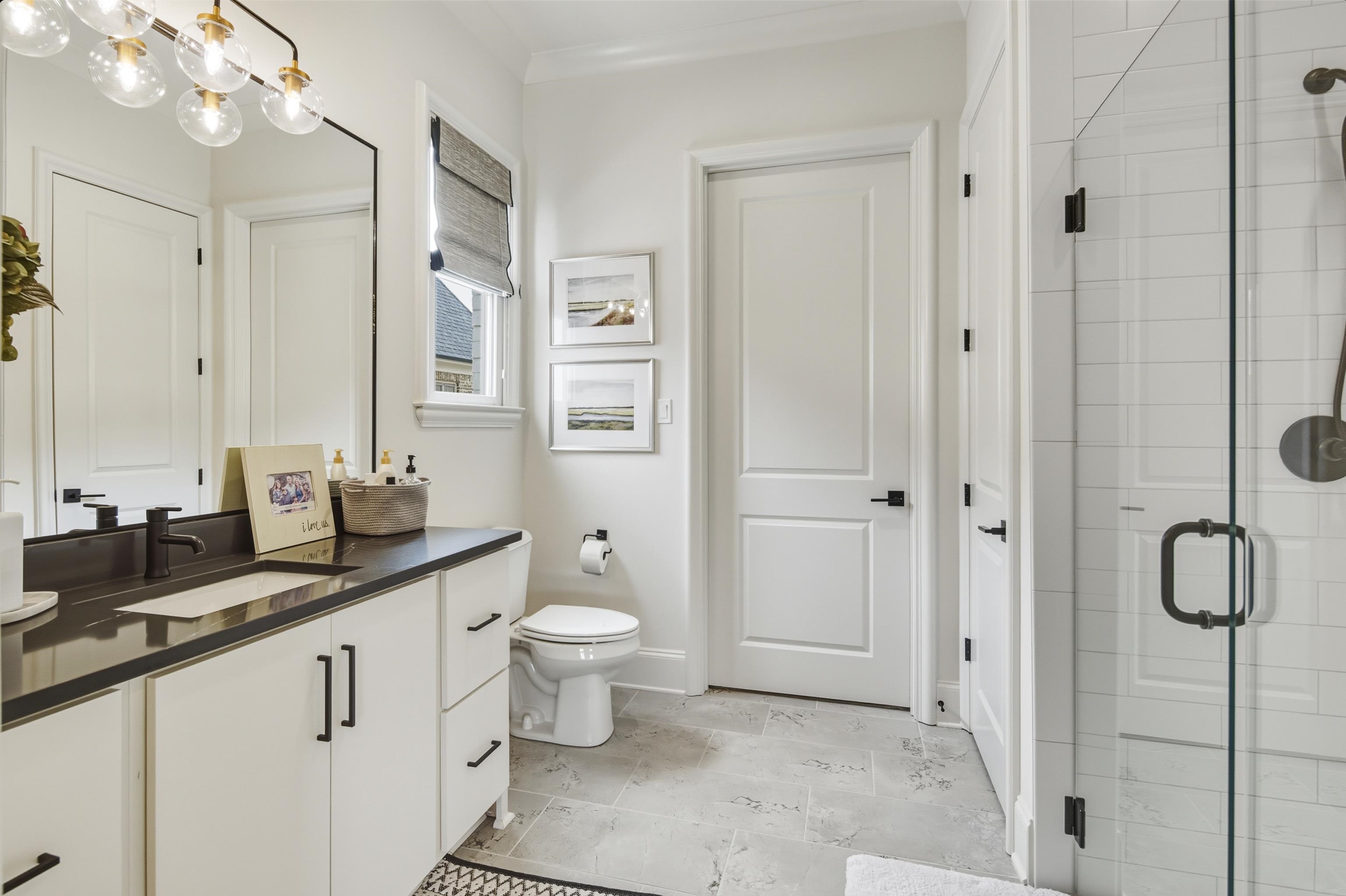 160 North Lake Road Piperton, TN 38017 - Photo 27 of 40 a bathroom with a double vanity sink a toilet and a mirror