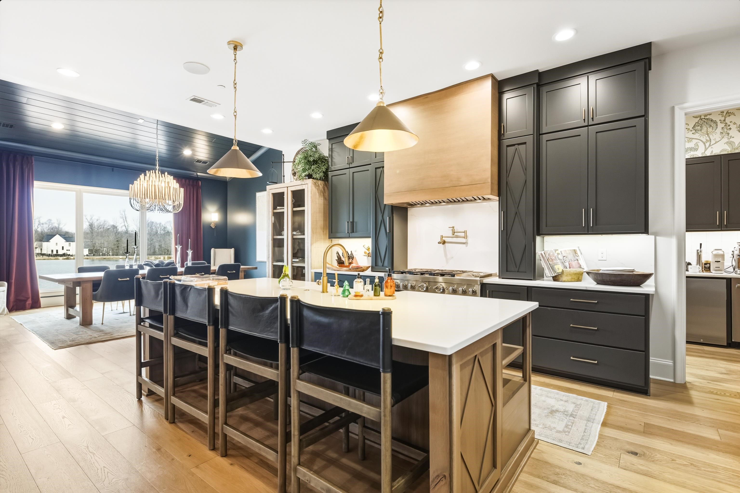 160 North Lake Road Piperton, TN 38017 - Photo 29 of 40 Kitchen with pendant lighting, light wood-style flooring, a kitchen island with sink, recessed lighting, and a chandelier