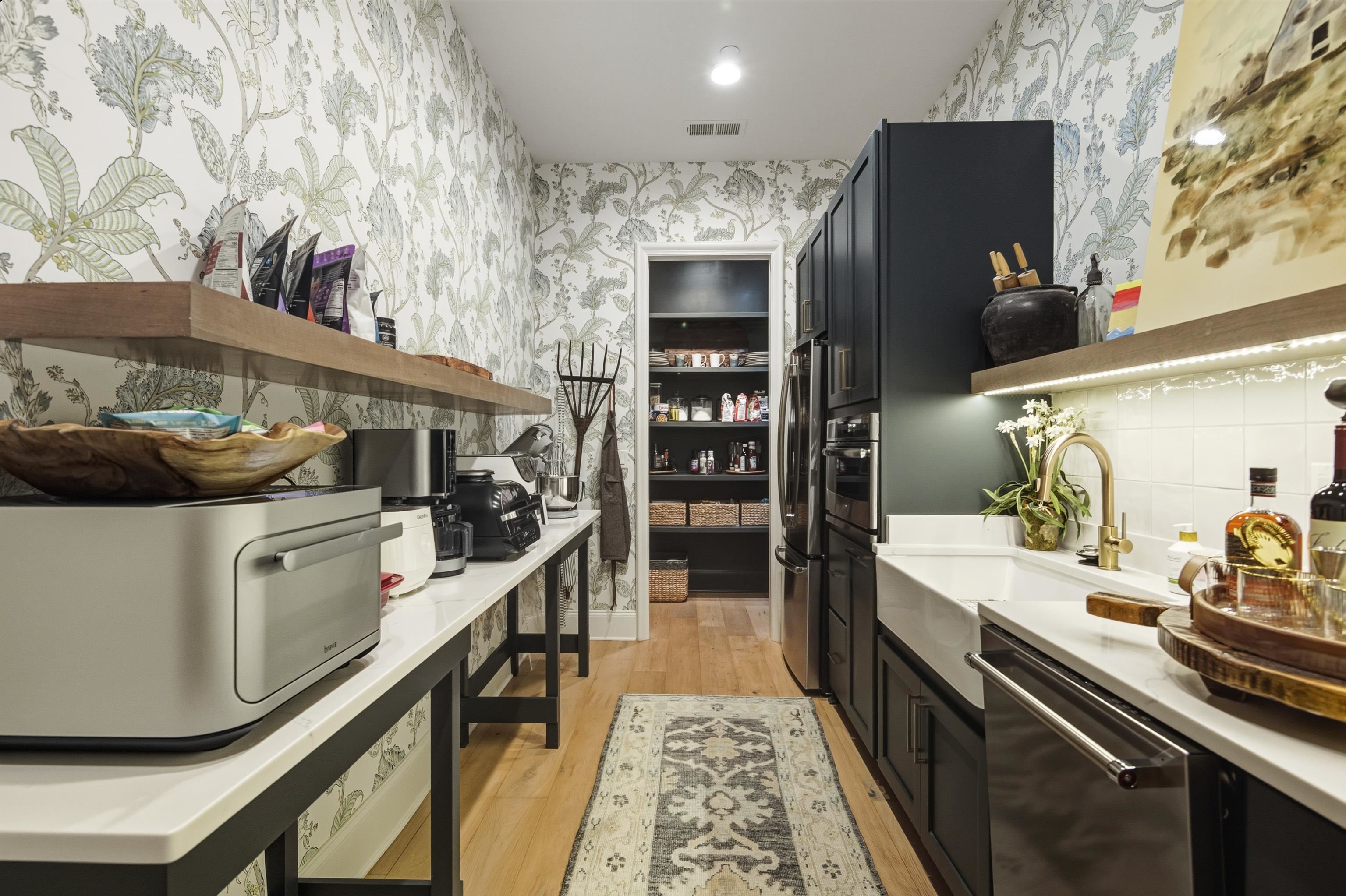 160 North Lake Road Piperton, TN 38017 - Photo 32 of 40 Kitchen featuring dark cabinets, open shelves, appliances with stainless steel finishes, light wood-style floors, and wallpapered walls