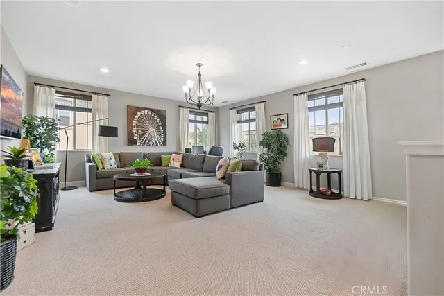 a living room with furniture and a chandelier