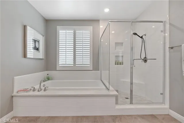 a bathroom with a tub sink and shower