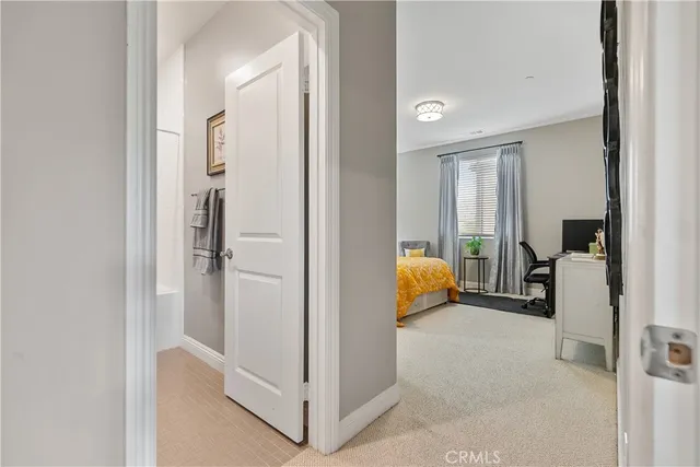 a bedroom with furniture and a lamp