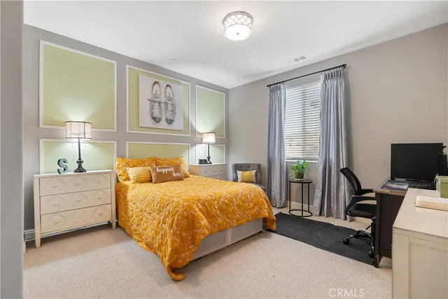 a bedroom with a bed and a desk