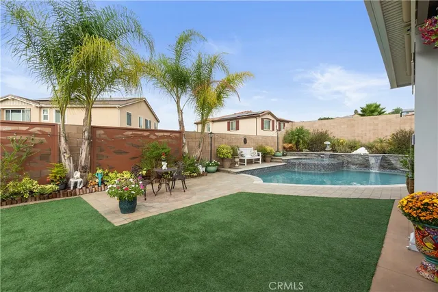 a view of a swimming pool with a garden and plants