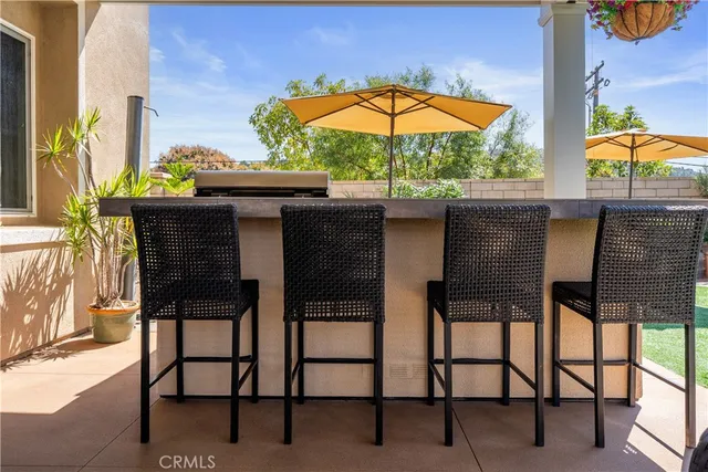 a view of two chairs and table under an umbrella