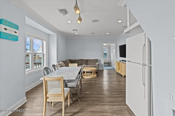 a kitchen with stainless steel appliances granite countertop a refrigerator and a stove top oven