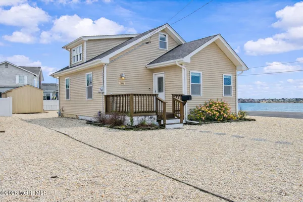a view of a house with wooden fence