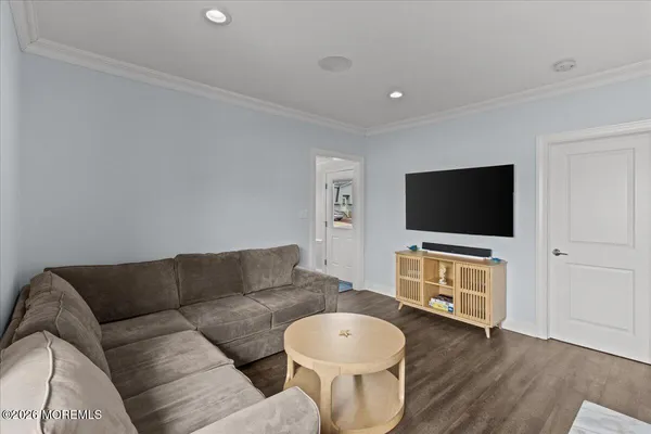 a living room with furniture kitchen view and a window