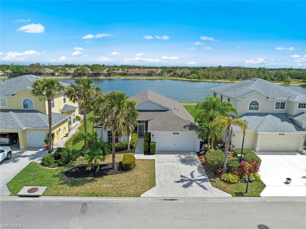 21629 Windham Run Estero, FL 33928 - Photo 1 of 48 a view of a lake with a building in the background