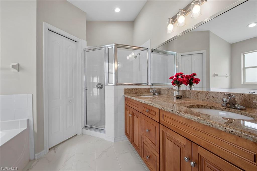 21629 Windham Run Estero, FL 33928 - Photo 15 of 48 a bathroom with a double vanity sink and a mirror
