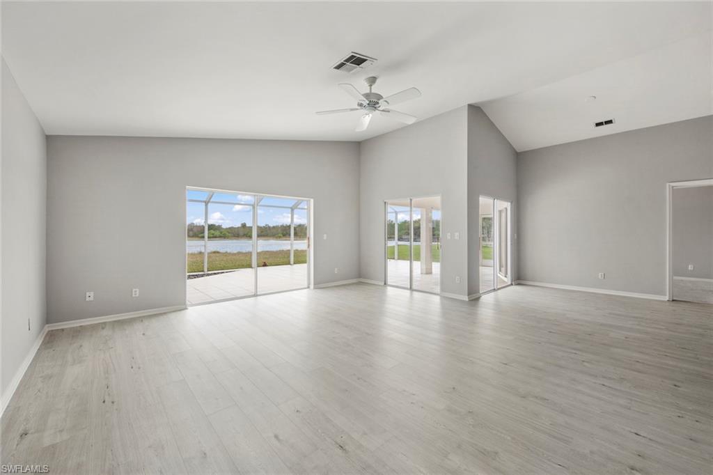 21629 Windham Run Estero, FL 33928 - Photo 3 of 48 a view of an empty room with a window and wooden floor