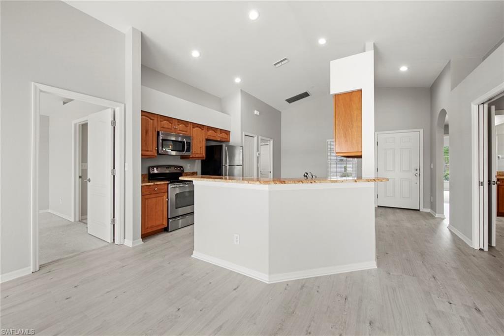 21629 Windham Run Estero, FL 33928 - Photo 7 of 48 a living room with couches and kitchen view with wooden floor