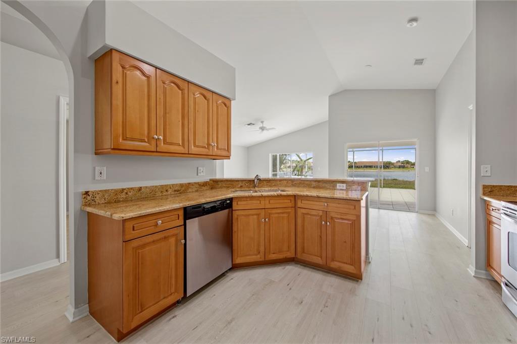 21629 Windham Run Estero, FL 33928 - Photo 10 of 48 a kitchen with stainless steel appliances granite countertop a stove a sink and a microwave