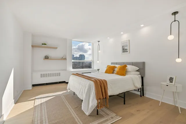 a bedroom with a bed and a table