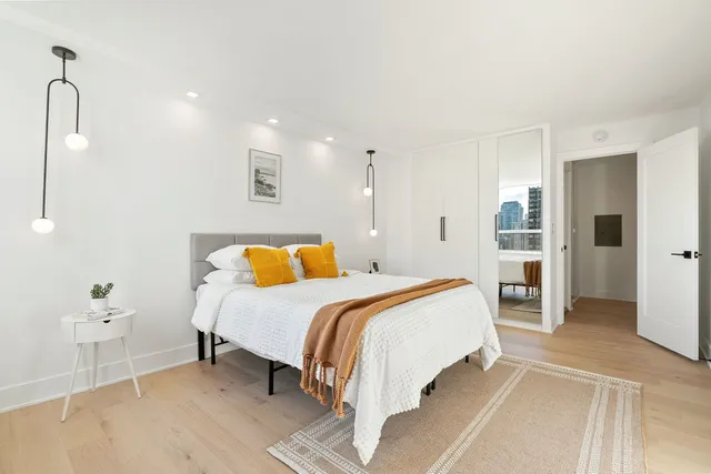 a spacious bedroom with a bed and closet