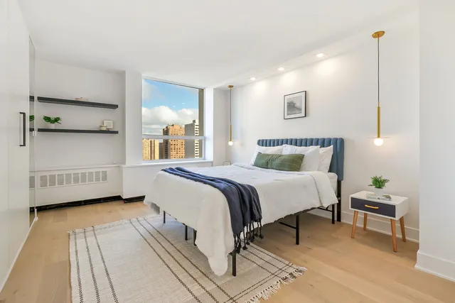 a bedroom with a bed and a night stand