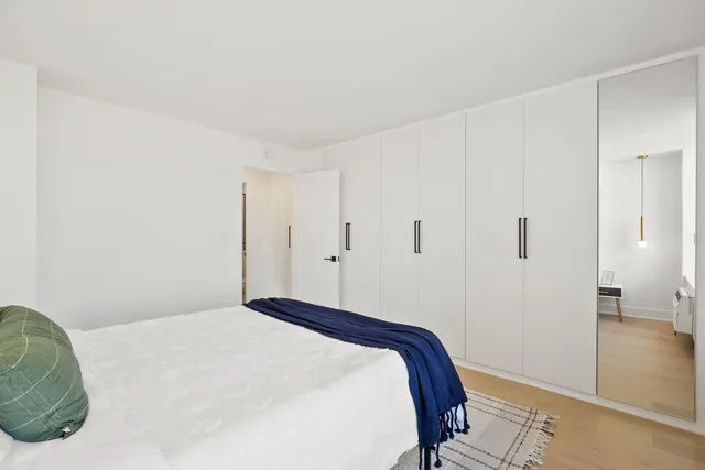 a bedroom with a bed and hallway