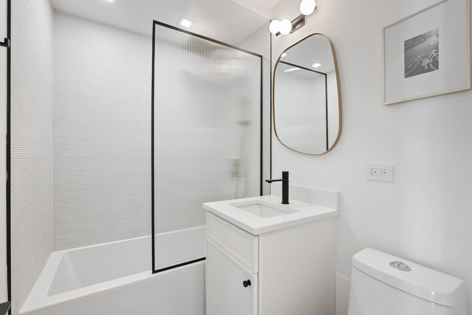 1460 North Sandburg Terrace, Unit 2001A Chicago, IL 60610 - Photo 25 of 39 a bathroom with a sink and mirror with toilet