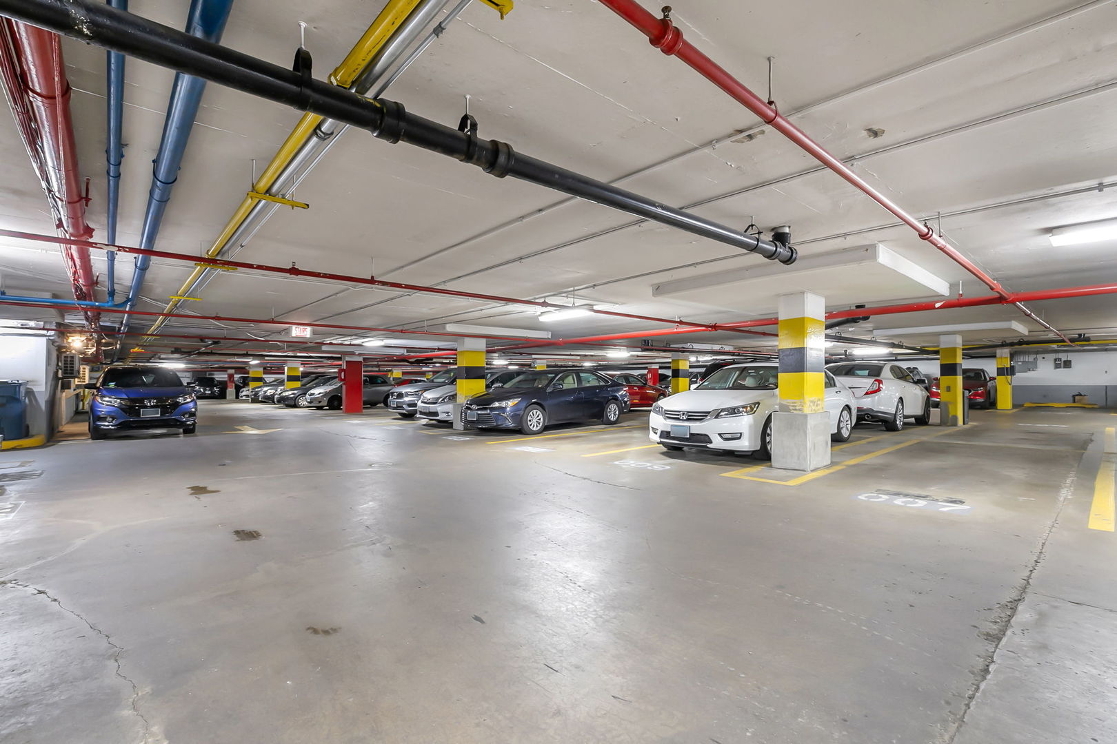 1460 North Sandburg Terrace, Unit 2001A Chicago, IL 60610 - Photo 35 of 39 a view of a garage with cars