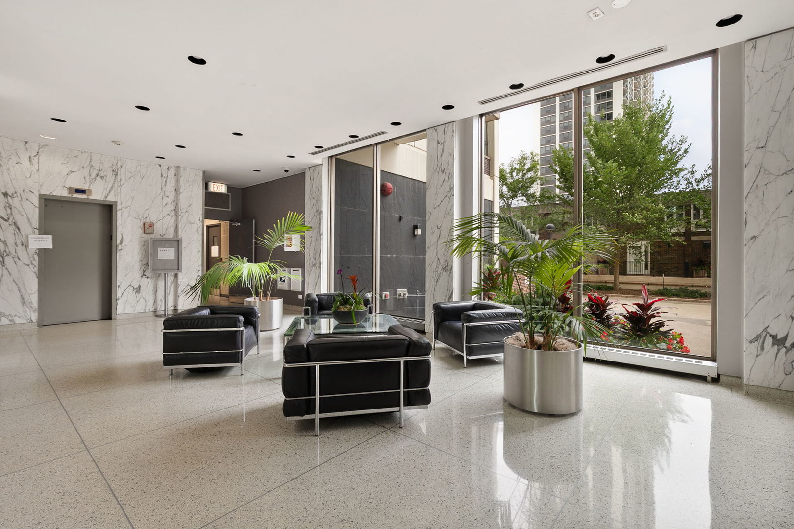1460 North Sandburg Terrace, Unit 2001A Chicago, IL 60610 - Photo 36 of 39 a lobby with furniture and floor to ceiling window