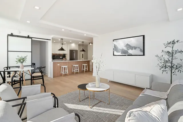 a living room with furniture and kitchen view