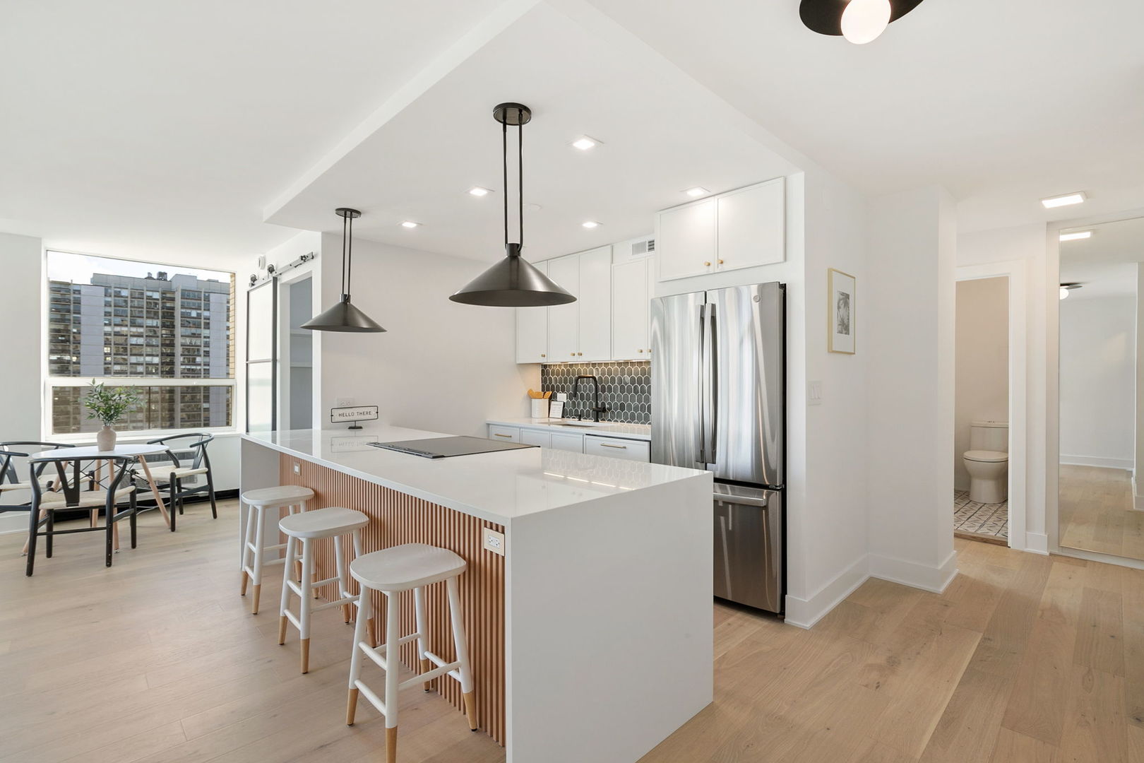 1460 North Sandburg Terrace, Unit 2001A Chicago, IL 60610 - Photo 9 of 39 an open kitchen with a table and chairs