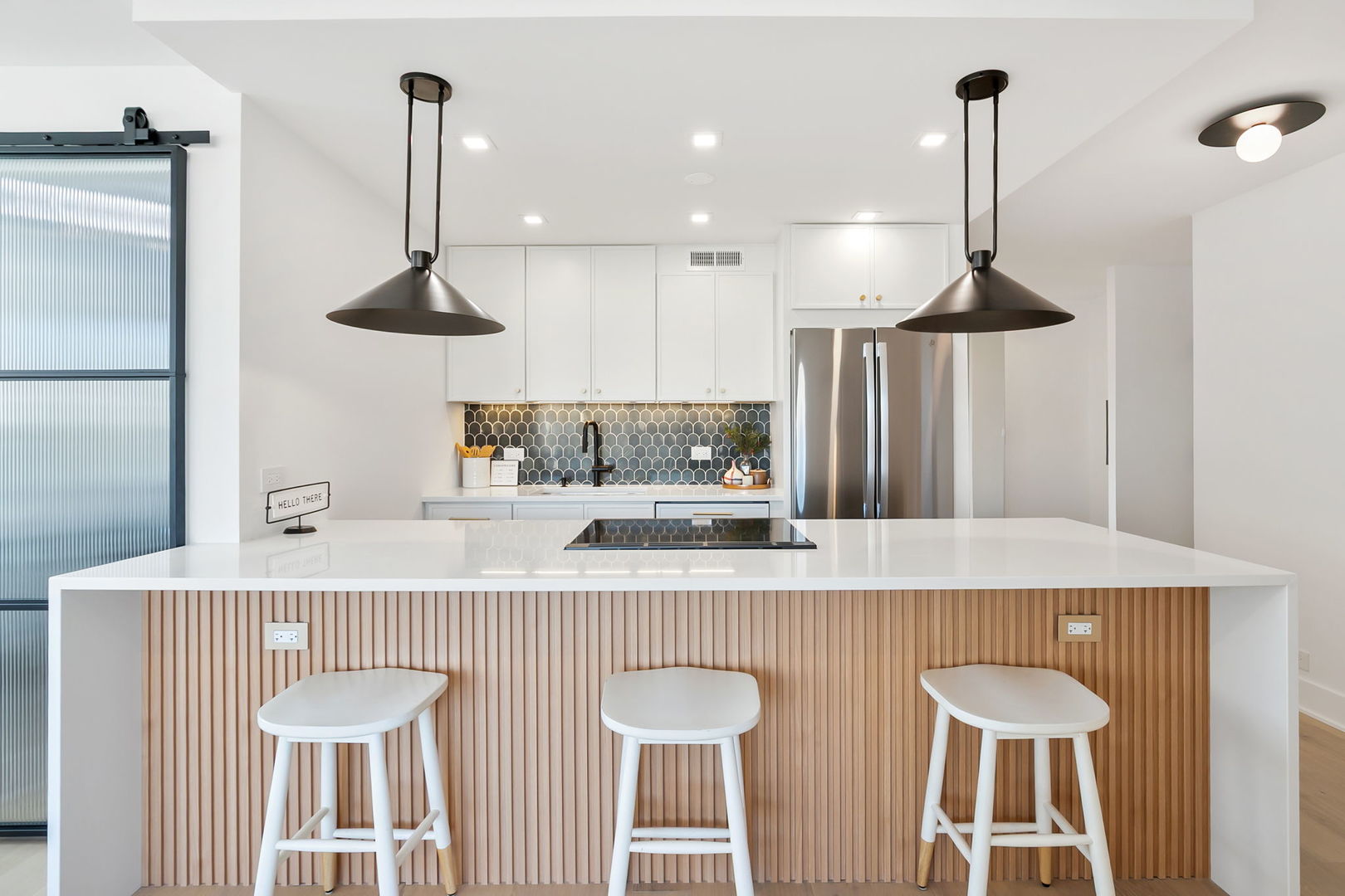 1460 North Sandburg Terrace, Unit 2001A Chicago, IL 60610 - Photo 10 of 39 a kitchen with stainless steel appliances a sink a table and chairs