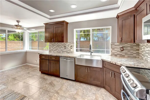 a kitchen with granite countertop a sink and a stove