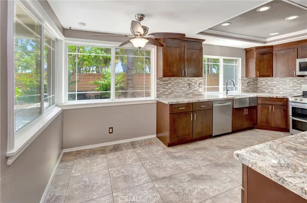 a bathroom with a granite countertop sink and mirror