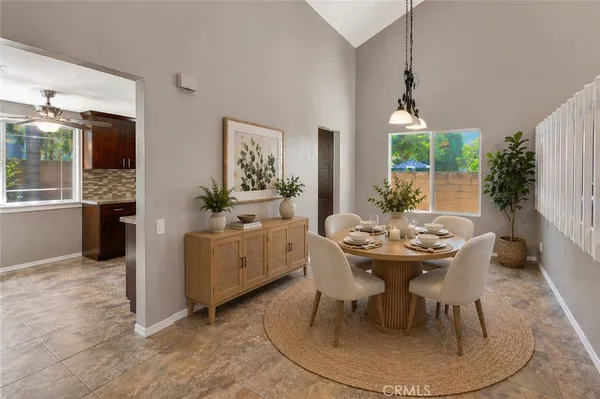 a dining room with furniture a chandelier and window