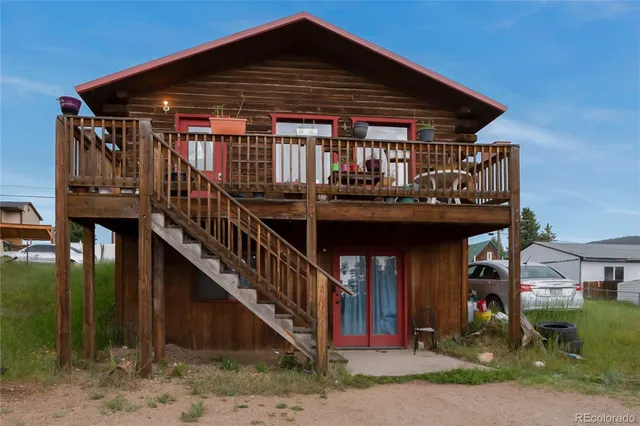 a view of house with deck and outdoor seating
