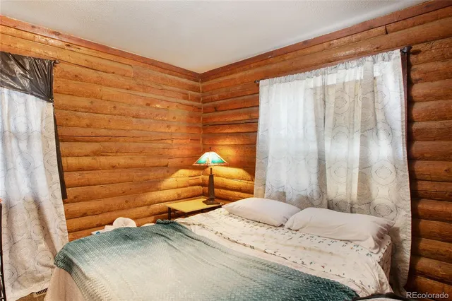 a bedroom with furniture and a baby crib