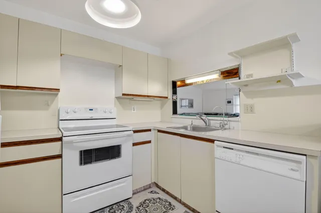 a kitchen with cabinets appliances and a sink
