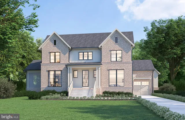 a front view of a house with a yard and green space