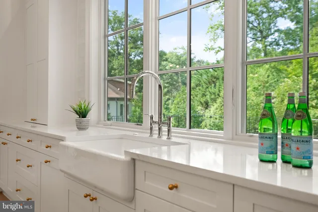 a kitchen with kitchen island cabinets and chairs in it