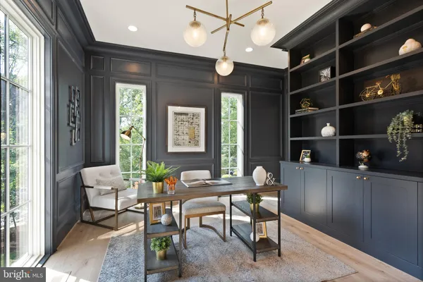 a dining room with furniture entryway and wooden floor