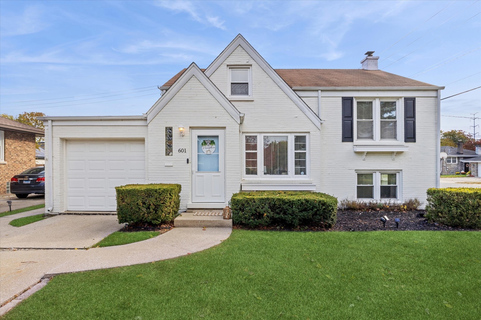 a front view of a house with a garden