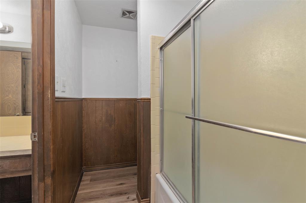 301 East 6th Street Krum, TX 76249 - Photo 21 of 29 Full size bathroom with new wood-style flooring.