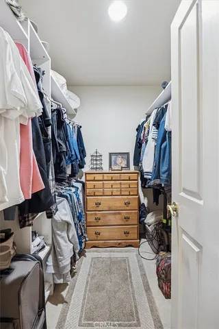 a view of a dining room with furniture a chandelier and wooden floor