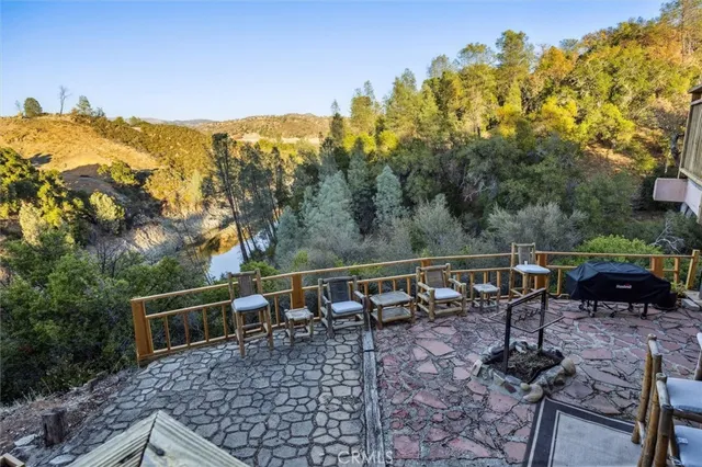 a view of a deck with furniture and a backyard